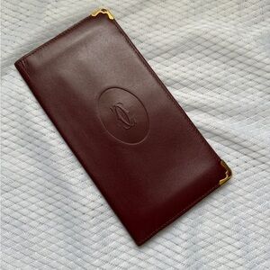 Cartier burgundy leather long card holder with gold corner accents